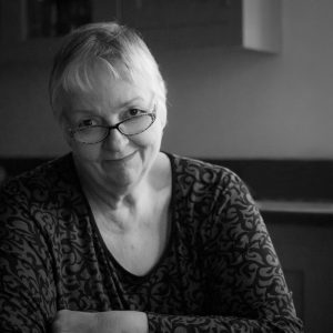 black and white image of smiling mature woman headshot photogrpahy by alison read